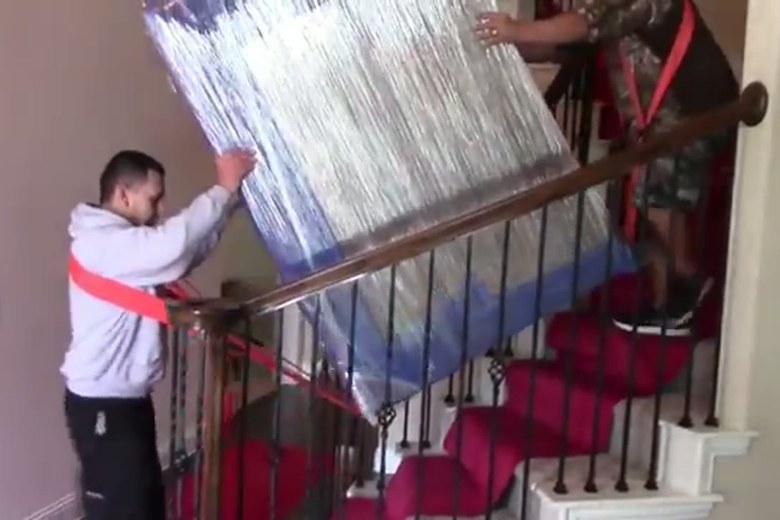 Guiding a mattress down a walk-up staircase